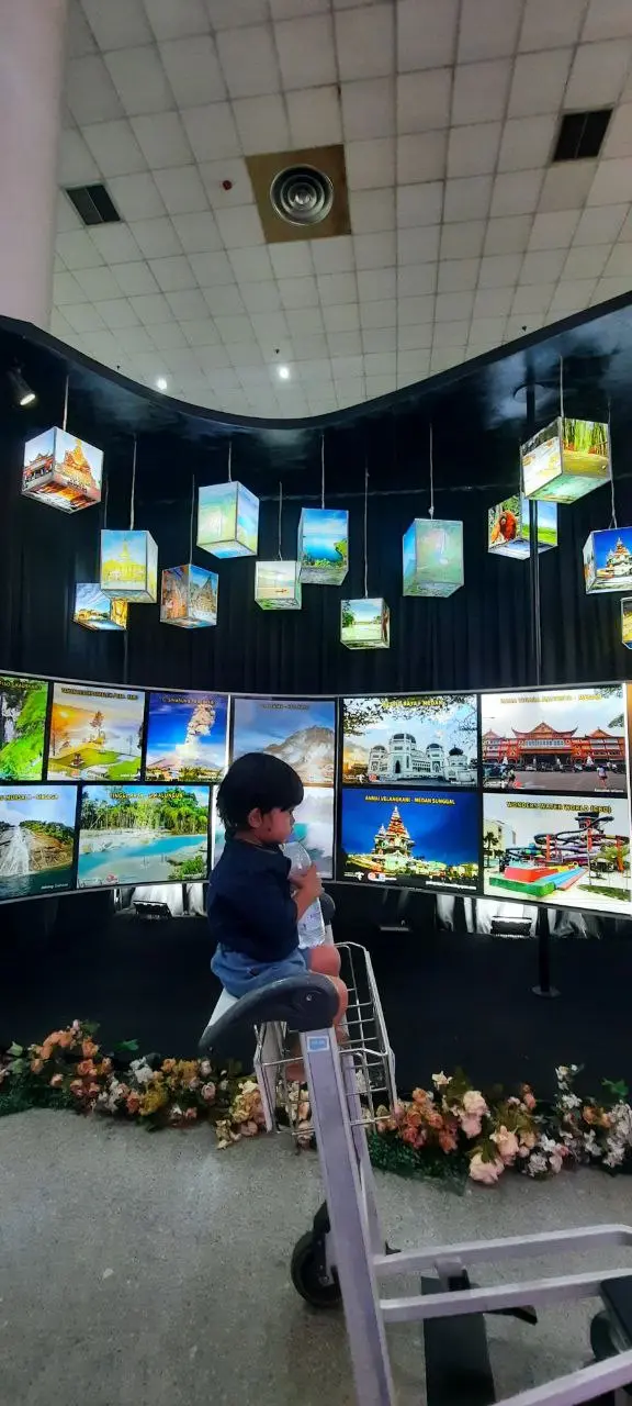 Anak mengamati pameran visual dan budaya